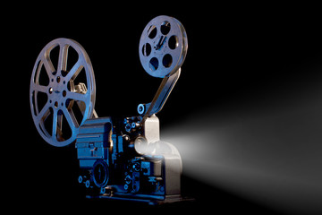 movie projector with film reels on black background