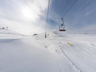 Fototapeta na wymiar Chairlift on ski resort in Greece
