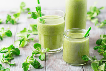 Detox diet concept: Green spinach smoothie on table