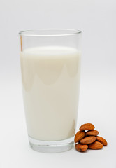 glass of almond milk on white background