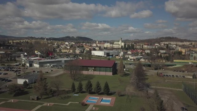 Gorlice, Poland - 3 9 2019: Panorama of the historic center of the European medieval city on the picturesque green hills. Trips to architectural monuments, temples, quarters and sports complex MOSiR