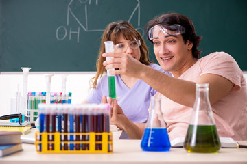 Two chemists students in classroom 