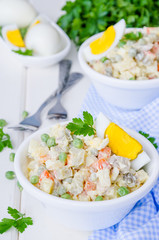 Russian traditional salad Olivier with vegetables and meat