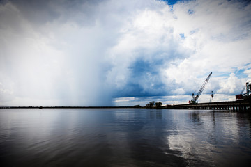 Lake with Rain in the Distance and Construction on a Bridge Over the Lake 