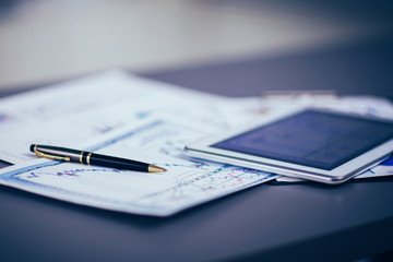 Tablet computer and financial diagrams in the workplace