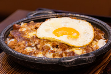 Japanese and Thai fusion food with fried egg on top.
