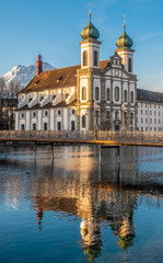 Fototapeta na wymiar The Jesuit Church of Lucern with Mount Pilatus in the background, Central Switzerland.