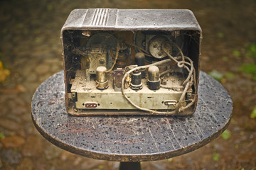 Оld disassembled radio with cobwebs and dust