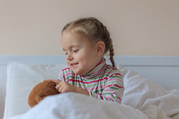Little girl holding teddy bear
