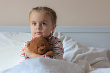 Little girl holding teddy bear