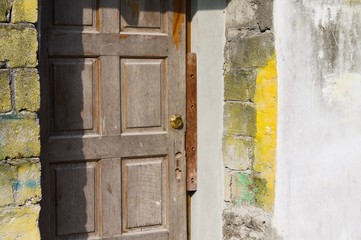 Wooden door and yellow brick wall (Ari Atoll, Maldives)