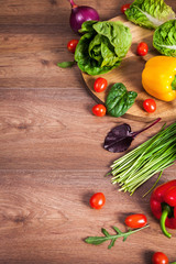 Various raw vegetables on brown wooden background