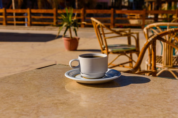 Cup of coffee on a table in street cafe