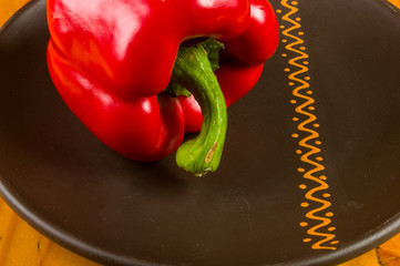 a freshest red paprika, bell pepper in ceramic plate
