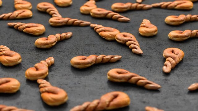 camera moves over a set of twisted buns spread out on a black table