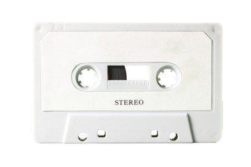 An old vintage cassette tape, obsolete music tech from the 1980s. Light grey plastic body, white label with the text Stereo, isolated.