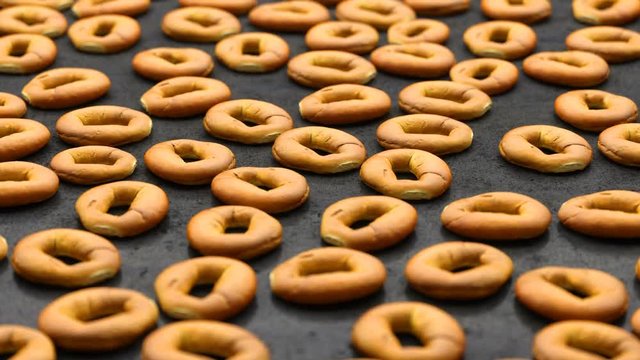 camera moves over a set of round buns spread out on a black table