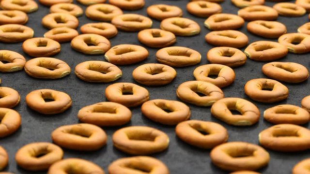 camera rotates over a set of round buns spread out on a black table
