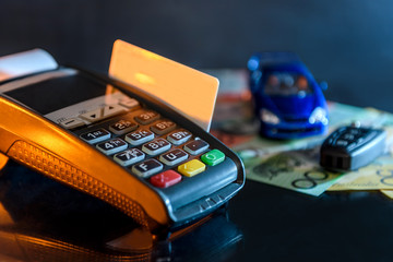 Credit card with terminal, toy car and australian dollar