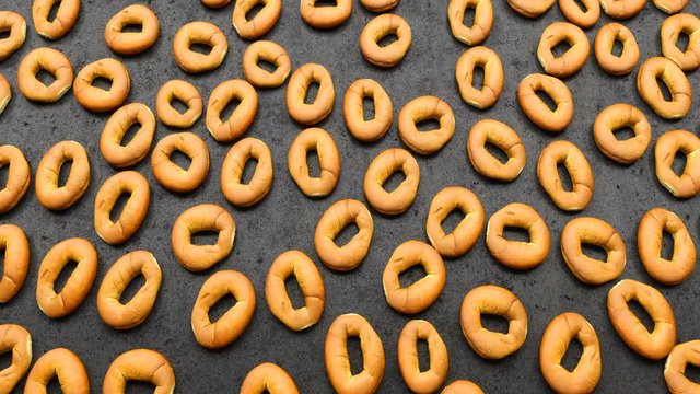 camera moves over a set of round buns spread out on a black table