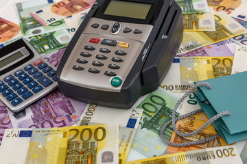 Banking terminal on euro banknotes background close up