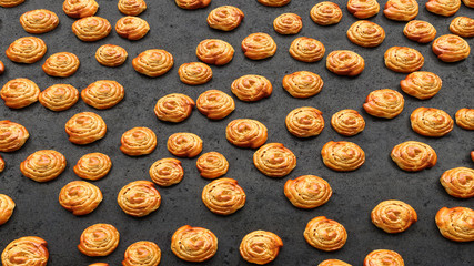 lots of mouth-watering French buns lying on black close-up, 3D illustration