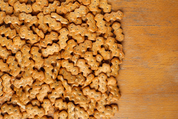 Composition of crackers with poppy seeds laid out on a wooden background