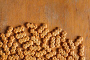 Composition of crackers with poppy seeds laid out on a wooden background