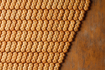 Composition of crackers with poppy seeds, spread out on a wooden background