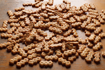 Composition of crackers with poppy seeds, spread out on a wooden background