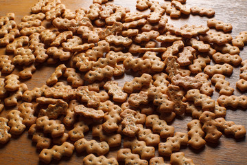 Composition of crackers with poppy seeds, spread out on a wooden background