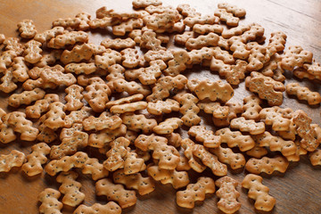 Composition of crackers with poppy seeds, spread out on a wooden background