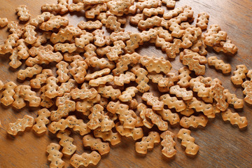 Composition of crackers with poppy seeds, spread out on a wooden background