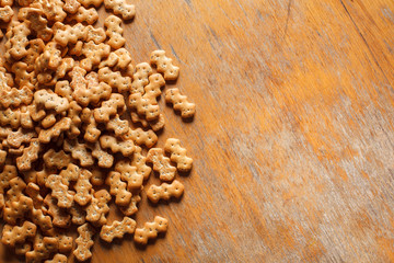 Composition of crackers with poppy seeds laid out on a wooden background
