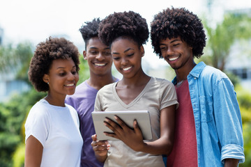 Laughing group of african american students with digital tablet