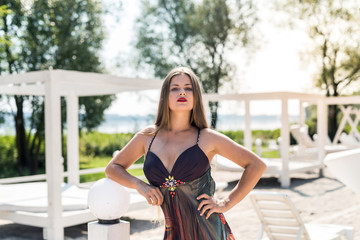 Attractive woman in a dress posing on the beach