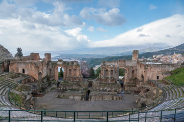Fototapeta premium Ruins of Ancient Greek Theater of Taormina (Tauromenion in Greek), Metropolitan area of Messina, Eastern Sicily, Italy. Founded by Greek colonists from Naxos