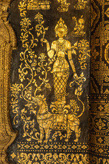 Fototapeta na wymiar Gilded carved facade of the Sim Viharn assembly congregation hall built in the AD.1560 at Wat Xieng Thong-Golden City-Golden Tree monastery. Luang Prabang Laos.