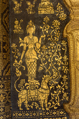 Fototapeta na wymiar Gilded carved facade of the Sim Viharn assembly congregation hall built in the AD.1560 at Wat Xieng Thong-Golden City-Golden Tree monastery. Luang Prabang Laos.