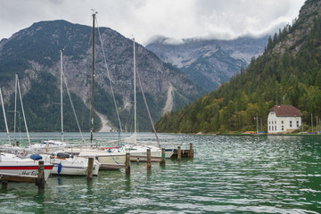 Fototapeta na wymiar Lake Plansee. Austria. Yacht pier the backdrop of the Alps