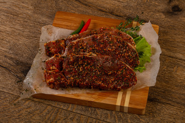 Raw marinated pork steak