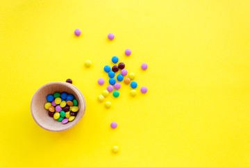 multi-colored little candy, yellow background