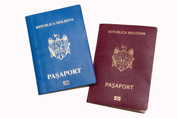 Biometric passports of citizens of the Republic of Moldova of red and blue colors isolated on white background. Covers of documents of different colors. Inscription - Republic of Moldova, Passport 