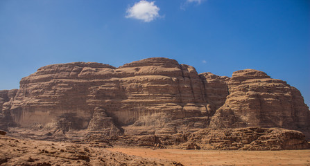 Fototapeta na wymiar picturesque panorama view of Middle East Wadi Rum desert mountain ridge on sunny blue sky background In Jordan 