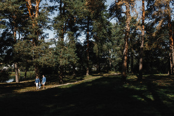 Family with a little boy walking in the park