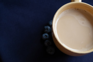 beautiful summer fresh delicious blueberry berry full of vitamins with a Cup of cappuccino on a natural dark cotton napkin