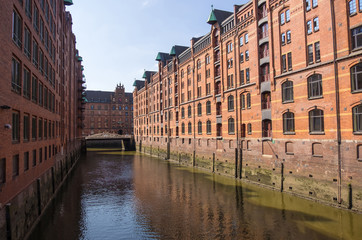 Hamburg, Germany - September 04, 2018: Canals and red buildings - the old warehouse district Speicherstadt in Hamburg, Germany