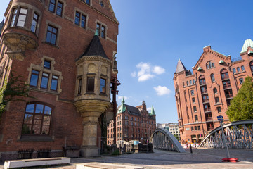 Fototapeta premium Hamburg, Germany - September 04, 2018: Canals and red buildings - the old warehouse district Speicherstadt in Hamburg, Germany