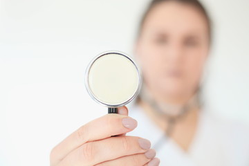 Portrait of beautiful female doctor. Medicine representative concept on brick background