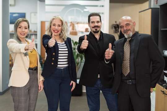 A cliche stock photo of group of worker looking at camra with ok symbol